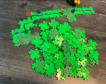 Load image into Gallery viewer, An overhead view of the pile of replacement tiles and the river.
