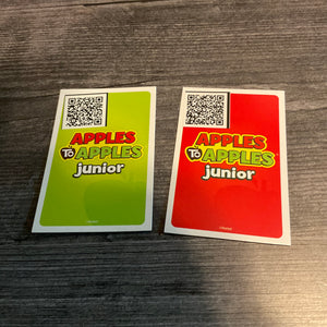 The back of the green and the red cards. A QR code sticker with the card's text is placed in the corner.