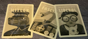 The role cards. They all have tactile shapes on them. The Hitler has a swastika, the fascist has an x on it, and the liberal has an o on it.