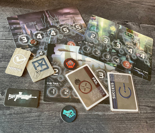 A bunch of the tokens and cards from the game laid out. all of the tokens and cards have transparent braille on them.