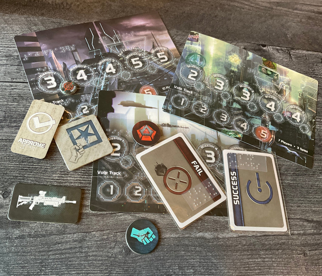 A bunch of the tokens and cards from the game laid out. all of the tokens and cards have transparent braille on them.