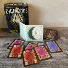 Load image into Gallery viewer, The diamond cards with transparent braille on them and the player shield
