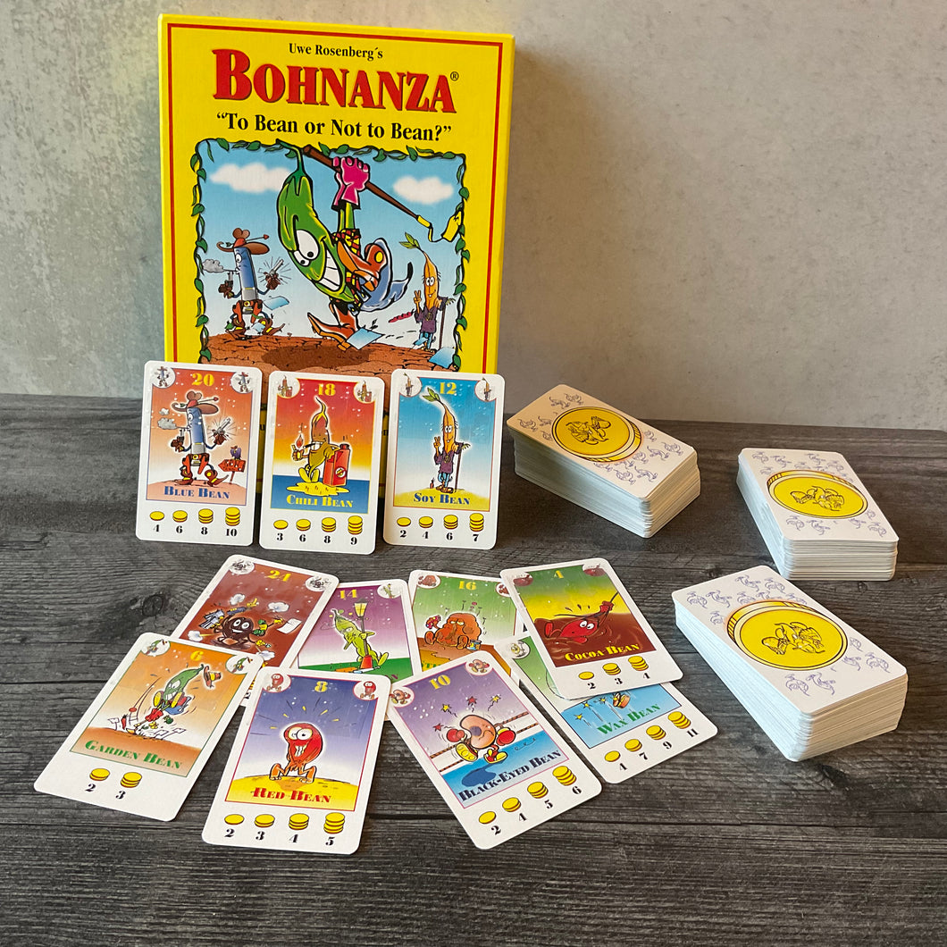 Bohnanza with the accessibility kit applied to it. Various beans can be seen with all the vital stats on the cards in braille.