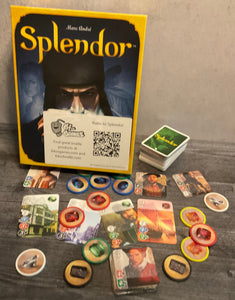 Shot of the Splendor game. Tokens with braille on them, the noble cards with transparent braille on them, and the game cards also have transparent braille on them.