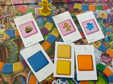 Load image into Gallery viewer, Close up on the play cards. The special cards have the words of the item on it. A letter indicates the color followed by the full spelling of the colors.
