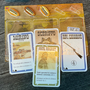 A close up of the player mat. The role card and the character card is shown along with the player's weapon and scope.