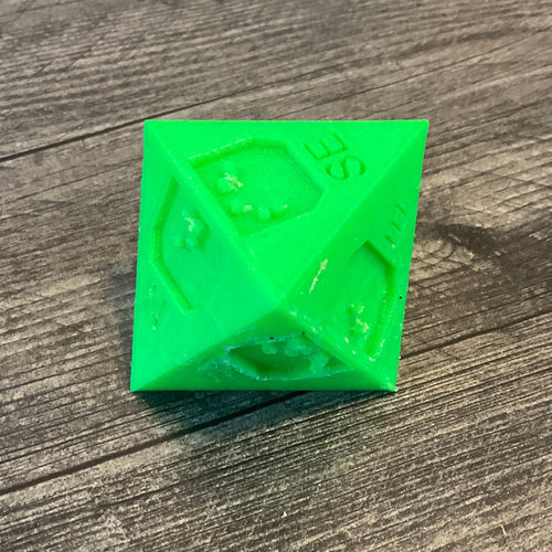 Die with SE showing on the top of the 8 sided die.