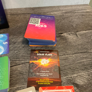 The ages cards. The main function of the age is on transparent braille stickers but the world's end text is on a QR code since you only use 1 per game.