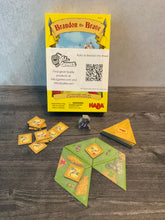 Load image into Gallery viewer, A shot of the game with the accessibility kit attached. The task tiles have letters on them in braille. The traingle tiles have tactile braille on them so players can feel the map.
