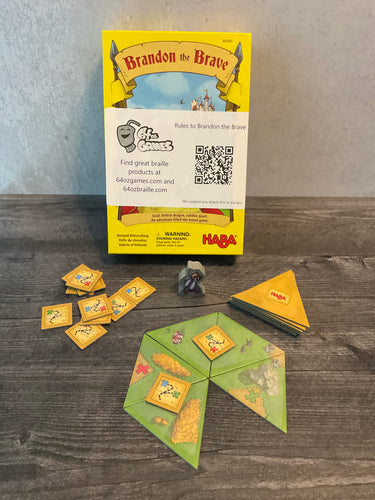 A shot of the game with the accessibility kit attached. The task tiles have letters on them in braille. The traingle tiles have tactile braille on them so players can feel the map.