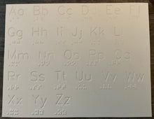 Load image into Gallery viewer, The white plastic sheet has print and braille letters. The print letters are extruded down.
