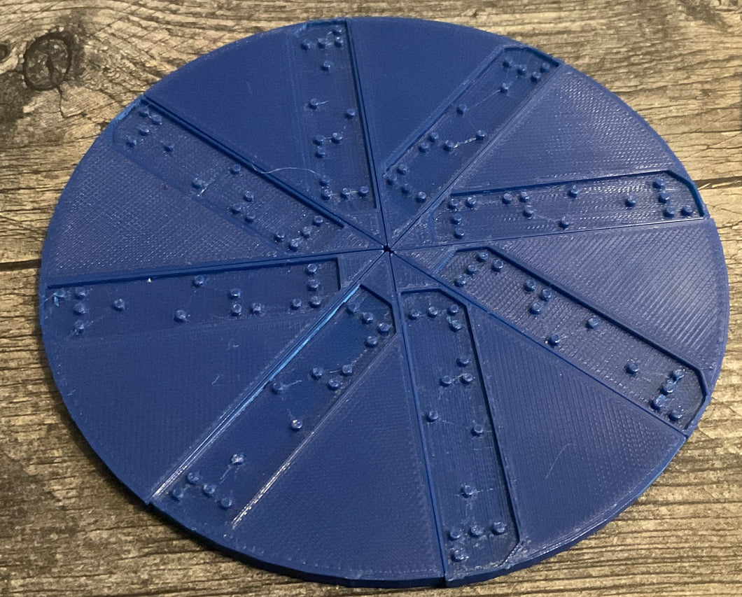A circle cut in to 8 different pieces. Each piece has an indented section that says 1/8 in braille.
