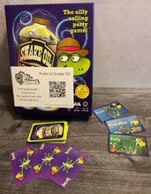 Load image into Gallery viewer, A shot of snake oil. Some customer cards and some product cards can be seen. All cards have transparent braille on them
