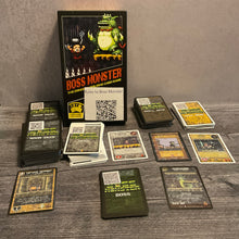 Load image into Gallery viewer, A shot showing all the various types of cards in boss monster, dungeon, hero, boss and spell cards. The cards have QR codes on the back and transparent braille on the front. Some of the cards also have braille on the back to help sort
