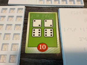 A close up on a point card that needs 2 2 dice, and 2 6 dice. It is worth 10 points