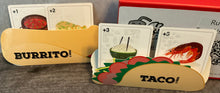 Load image into Gallery viewer, A close up on the taco and burrito folders. They are loaded with terrible food cards

