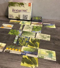 Load image into Gallery viewer, The game sort of laid out with the market in the middle and the player gardens towards the front and the back. Every card has transparent braille on it showing it&#39;s function.

