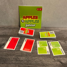 Load image into Gallery viewer, A picture showing some of the Apples to Apples Jr. cards with transparent braille on them. The flavor text is not shown in the braille but the back of the cards have QR code stickers that link to the full flavor text.
