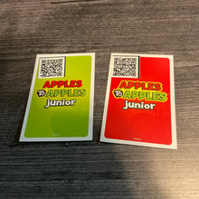 Load image into Gallery viewer, The back of the green and the red cards. A QR code sticker with the card&#39;s text is placed in the corner.
