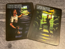 Load image into Gallery viewer, The camp and torch cards. They look pretty similar in print so a lot of players make a mistake and I&#39;ve often heard it called the hardest part of the game but you won&#39;t because their names are in braille.
