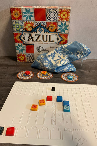 A shot of the Azul box with one of the thermoformed replacement boards with tiles on it. Each tile has a transparent braille sticker on them.