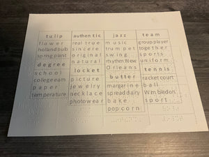 A close up of one of the cards. The words are organized in 4 columns with the print rotated 180 degrees from the braille. This will allow a sighted person to see the words even if the blind person's hands are on the braille