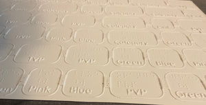 close up on the thermoformed game board. Both print and braille can be read