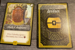 A close up view of the front and the back of artifact cards. Braille is on both sides to help separate it from the other decks
