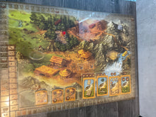 Load image into Gallery viewer, The main board with a plastic transparent overlay on it. Cards and tools are laid out in their appropriate places.
