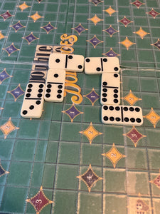 A closer shot of the dominoes on the board. You can see the point markers with braille on them