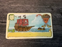 Load image into Gallery viewer, A close up on a pirate card. Transparent braille explains the function of the card.
