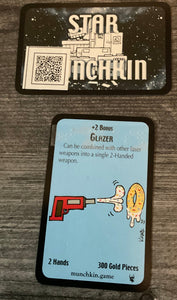 An example treasure card. QR codes are on the back with the full text of the card and the card's name is on the front in braille
