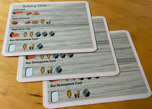 Load image into Gallery viewer, Close up on the building cost reference cards. They are full color with braille.
