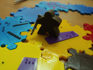A close up of the "blind meeple" replacement for the robber, complete with cane.