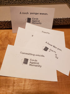 Additional Prompt Cards for CAH. The cards are in large print with braille on them. Committing suicide, A loser like you, Poverty and A much younger woman are shown on the cards in both print and braille