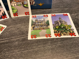 face up cards with houses and numbers on them. All cards have braille stickers on them.